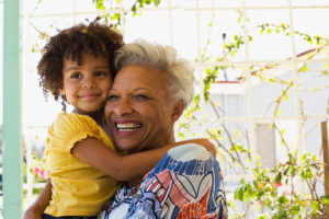 A happy, healthy child and grandmother who received behavioral healthcare services with Family Solutions