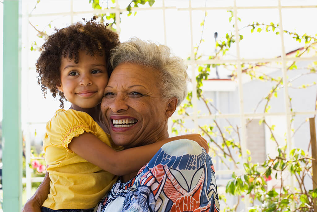 A happy, healthy child and grandmother who received behavioral healthcare services with Family Solutions